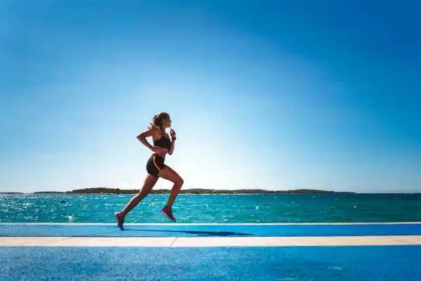 Woman running showing strong leg muscle Nottinghamshire